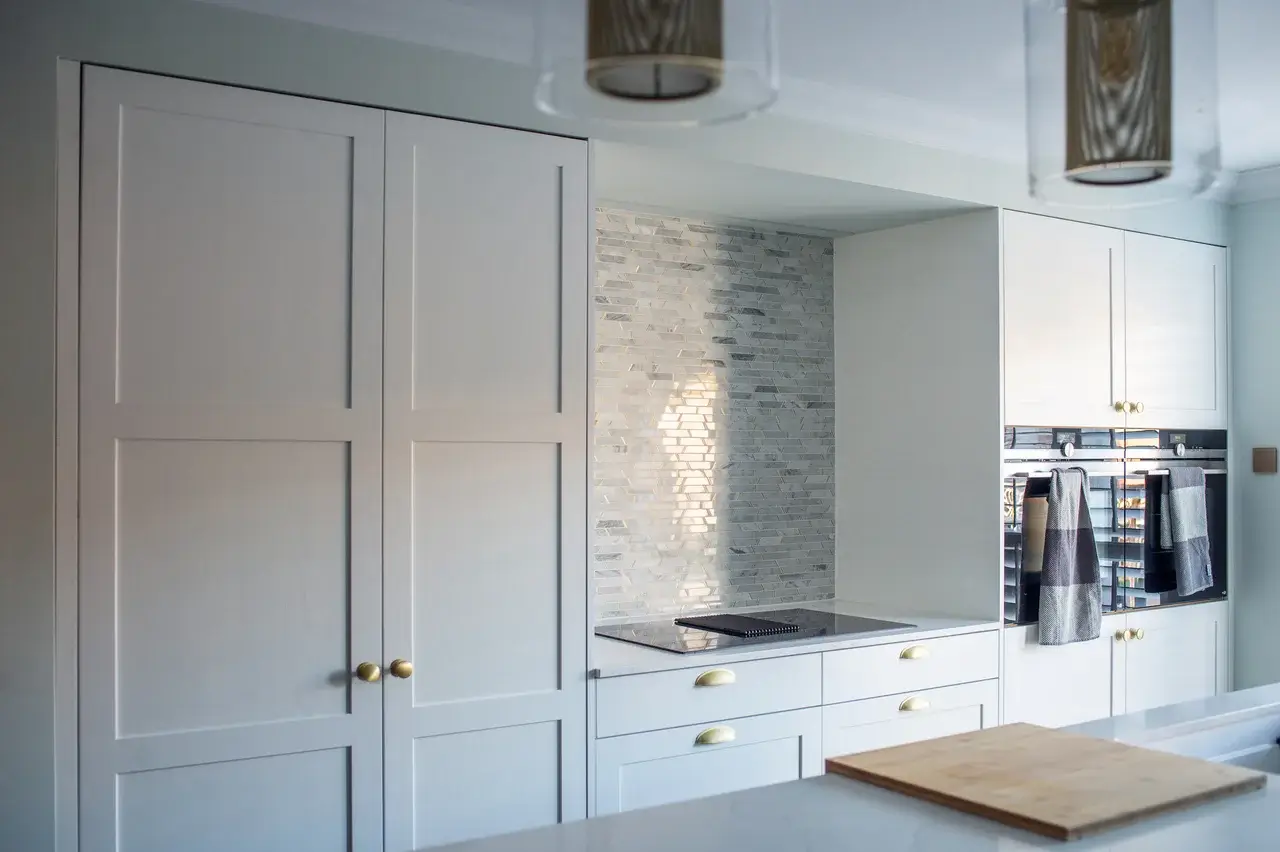 bespoke modern kitchen with grey tile splashback and gold accents