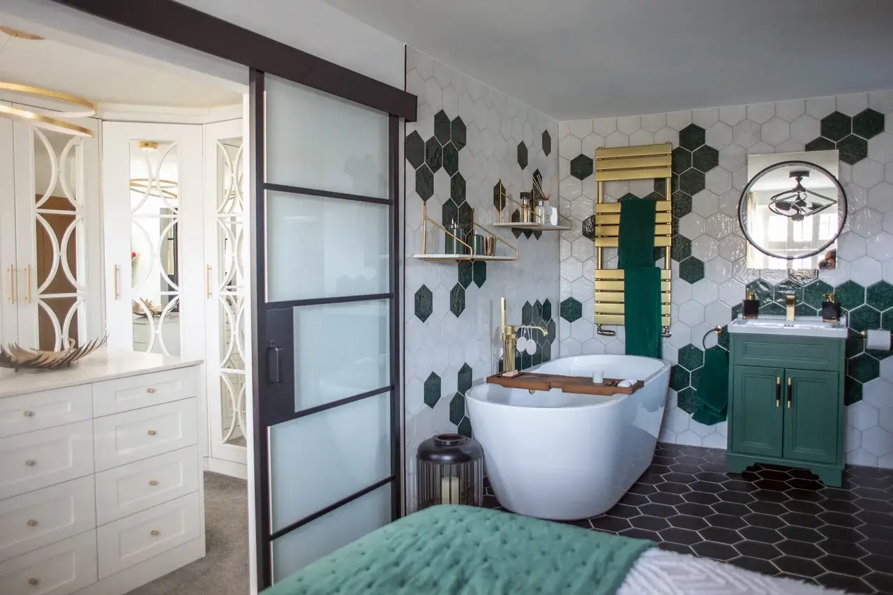 modern en-suite with rolltop bath and green marble tiles